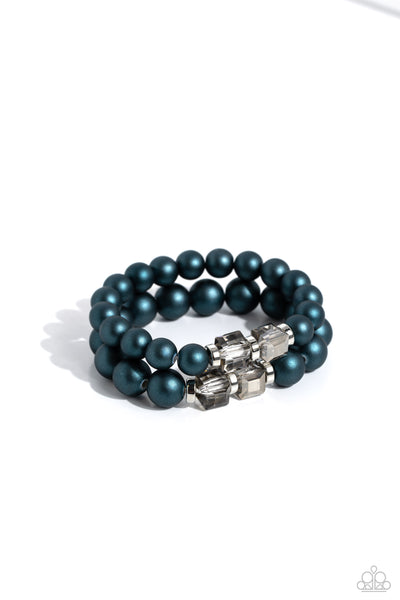 Paparazzi Shopaholic Season Necklace and Shopaholic Showdown Blue Bracelet

P9RE-BLXX-245QB
Two strands of oversized blue beads featuring a subtle shimmer, silver accents, and clear gray cubed beads stretch around the wrist, creating refined,